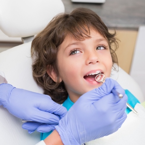 Young patient receiving treatment by board certified pediatric dentist