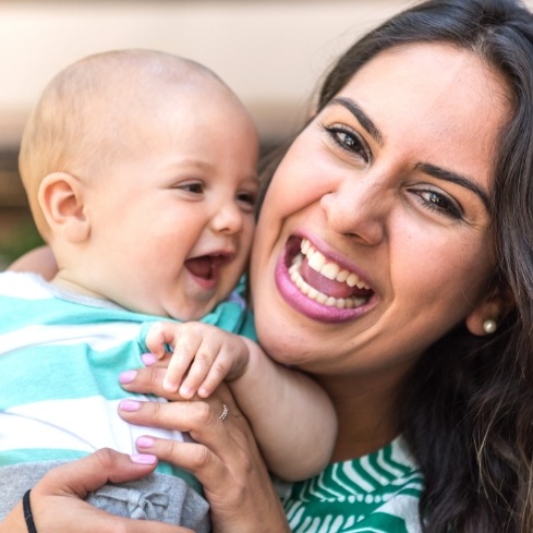 Mother and baby laughing after treating symptoms of lip and Tongue-Tie