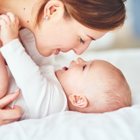 Mother providing laser frenectomy aftercare for baby