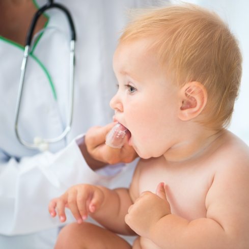 Pediatrician examining baby