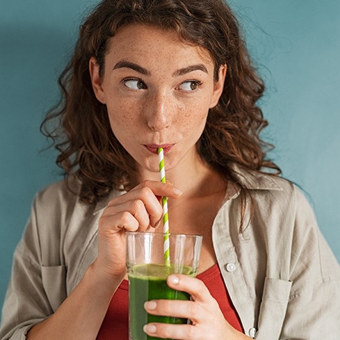 woman drinking through a straw after a laser frenectomy in South Loop