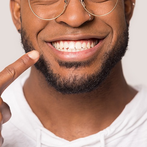 adult man smiling and enjoying the benefits of a laser frenectomy in South Loop