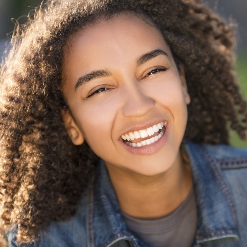 Teen smiling happily after lip and Tongue-Tie treatment