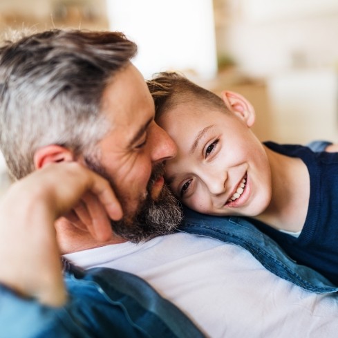 Father and child smiling together after Tongue-Tie treatment