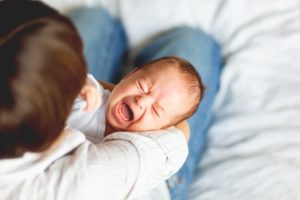 baby crying and needing tongue-tie treatment