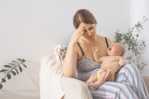 a frustrated nursing mom and crying baby