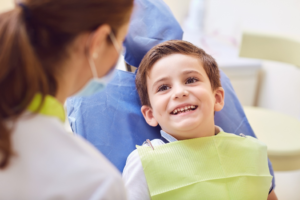a child smiling while at the dentist 
